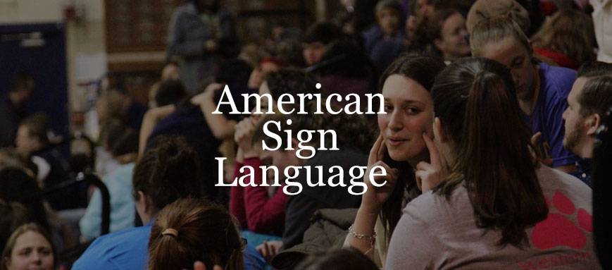 A woman making signs to another person, overlaid with "American Sign Language"