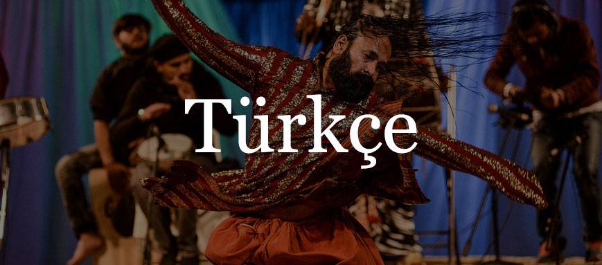 A man in traditional dress dancing on stage, overlaid with Turkish text